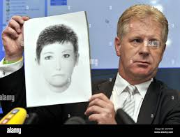 McCann Spokesperson Clarence Mitchell holding an e-fit of a Victoria  Beckham lookalike who may have information about missing Madeleine McCann  Stock Photo