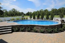 Radiant 18x32 Semi Inground Freeform With Walk In Steps Pavers And Lights Inground Pool Landscaping In Ground Pools Swimming Pools Inground