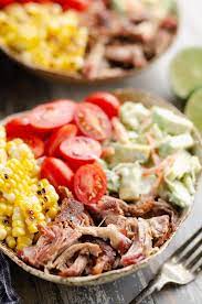 Made in the slow cooker with only a few ingredients, it's low in fat, packed with protein, and paleo / whole30 approved! Pulled Pork Bowls With Avocado Slaw