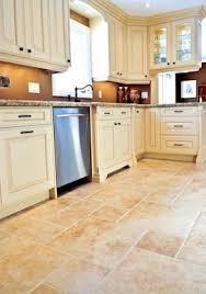 In this kitchen, we see a natural stone in elegant grey and white that blends well with the home's decor and is one of the best tiles for kitchen floor. Choosing The Best Tile The Pros And Cons Of Ceramic Porcelain Stone Cement And Glass Antique White Kitchen Kitchen Remodel Antique White Kitchen Cabinets