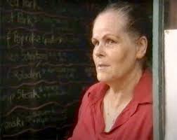 This is Edith Roth in front of the Bank of Pocahontas with a dapper young  boy posing behind her. Dale Hawkins is this the Crists Cafe next to the  Bank? I'm not