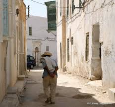 Long protected by its monumental walls and babs (gates), most of it is given over to quiet residential streets that have. Old Man In The Medina Kairouan Tunisia