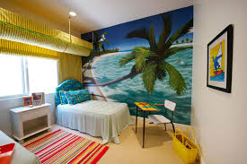 A single bamboo wall, a bamboo rug, lots of potted greenery and bright tropical bedding create an ambience. Never Miss Summer With These Tropical Bedroom Design Ideas