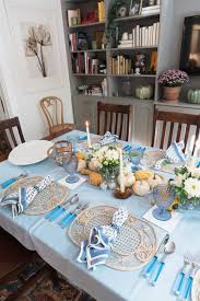 Light tablecloth and napkins are beautifully emphasized by dark blue glasses and silver cutlery in this arrangement. Blue And White Thanksgiving Table Ideas Darling Down South