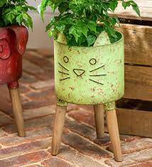 Clean and simple, the design is the perfect piece to refresh an empty corner or anchor small or large plants alike. Rustic Metal Cat Planter With Wooden Legs Plowhearth