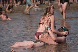 Naked girls wrestle in muddy water and straddle each other at Woodstock music  festival in Poland | The Irish Sun