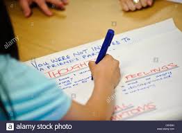 pen writing on large sheet of flip chart paper the words