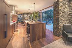 The dark wooden floor is just the right amber color to unify with the cabinets in the room. Hardwood Floor And Walnut Cabinets