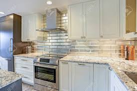 silver backsplash, white shaker.. stock