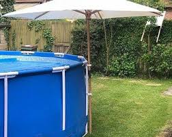 Pin By Adela Rivera On Piscina In 2021 Pool Umbrellas Swimming Pools Pool Landscaping