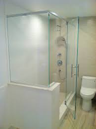 This Frameless Bath Enclosure Surrounds A Shower With A Bench Seat The Header Support Bar Across The Top Shower Doors Frameless Shower Doors Frameless Shower