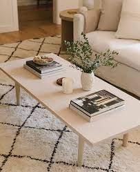 To keep your coffee table balanced, vary the scale of display items and stack or group like objects together. Mastering The Art Of Styling Your Coffee Table Style Rip Tan