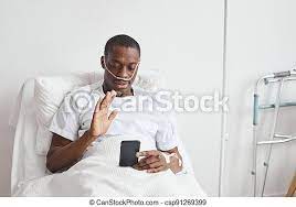 African american man using video chat in hospital. Portrait of african- american man speaking by video call in hospital and | CanStock
