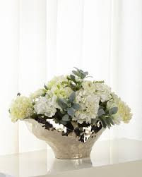Pair it with white lace linens for an elegant tablescape display, or set it on the entryway console for a dash of garden style. John Richard Collection Silver Moonlight Floral Arrangement