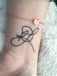 Parents across the world have made the sentimental choice to get their childs name tattooed on them even before the child has arrived. Initial Tattoo Rl Kids Initial Tattoos Initial Tattoo Cool Wrist Tattoos
