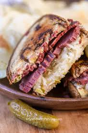 The reuben sandwich is an american grilled sandwich composed of corned beef, swiss cheese, sauerkraut, and russian dressing, grilled between slices of rye bread. Reuben Sandwich Spend With Pennies