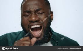 Closeup bored african male person yawning at camera in light background. —  Stock Photo © stockbusters #534116916