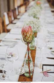 Protea In Empty Coke Bottle Makes For Beautiful Decor Wedding Flower Decorations Protea Wedding Wedding Venue Decorations