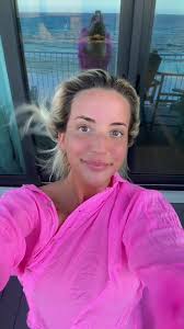 Bright Pink Outfit Amid Ocean View: A Serene Moment