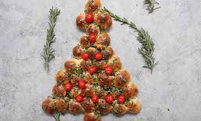 Christmas tree shaped appetizers mix together mayonnaise, dry ranch salad dressing mix and one cup of shredded cheddar cheese. This Cheesy Christmas Tree Pull Aparts Recipe Is An Easy Holiday Recipe Yummy Appetizers Delicious Appetizer Recipes Christmas Appetizers