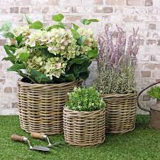 When overflowing with bright greenery or blooms, it can make even the drabbest entryway feel important. Grey Buff Rattan Round Wicker Planter The Basket Company