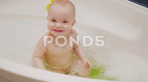 And since wet baby bottoms are slippery bottoms, the tub bottom shouldn't be. Small Baby Boy Sitting In Bath With Soap Stock Video Pond5