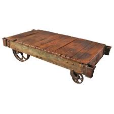 Crafted with solid pine wood treated to a weathered gray finish, this generously scaled coffee table is rustic. Antique Factory Cart Coffee Table At 1stdibs