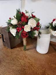 A more dramatic botanic decoration is lining your aisle with potted trees to bring a touch of the outdoors inside. Wedding Bouquet Winter Red Pine Bouquet Sola Bouquet Red Etsy Red Bouquet Wedding Christmas Wedding Flowers Christmas Wedding Bouquets