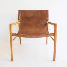 simplistic but sophisticated pasadena leather sling accent chair nowinstock chair simplistic sophisticated