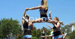 Cheerleaders team throw up girls in the ... | Stock Video | Pond5