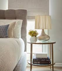 Gray Button Tufted Headboard With Round Clairemont Round Side Table And Silver Lamp Transitional Bedroom Side Tables Bedroom Elegant Bedroom Chic Bedroom