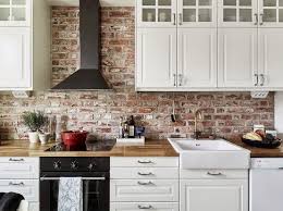 The marble counters, subway tile backsplash, and white cabinetry are classic timeless. I Like The Brick And The Counter Tops But Qould Chamge The Range And Stove To Something Exposed Brick Kitchen Trendy Kitchen Backsplash Farmhouse Kitchen Decor
