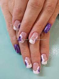Making sure your hand is steady, paint white crescents on your nail tips. Purple Glitter With White French Tips And One Stroke Flower Nail Art Flower Nails November Nails Artificial Nails