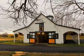Black And White Barn Style House A Dreamy Black White Barn For A Lifelong Equestrian Stable Style White Barn Barn Construction Barn Renovation