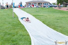 Use inflatable bowling pins and tubes for people to 'roll' in. How To Build A Huge Slip N Slide Fun For All Ages All Things Thrifty