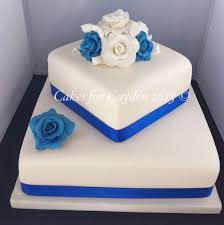 2 Tier Square Ivory And Royal Blues Wedding Cake With Hand Made Sugar Roses Square Wedding Cakes Tiered Wedding Cake Square Wedding Cakes Simple