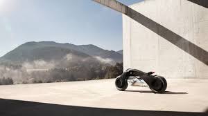 Futuristic Two Wheeler Glides Through The Auditorium The Jet Black Triangular Frame Illuminates The Blue And White Bmw Logo The Bmw Motorrad Bmw Concept Bmw