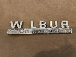 Vintage Metal Auto Dealer Emblem Wilbur Ford West Union Iowa (04-48)