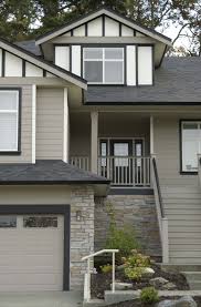 Tudor Estate Soft Mushroom With Contrasting White And Black Feature Colours A Striking Colour Combo Exterior Paint Color Exterior Paint Grey Exterior