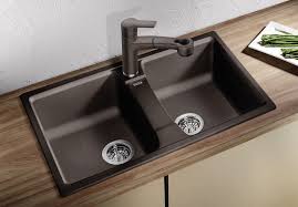 Industrial style faucets, vent hood, and pendant lighting add a bit of flair to the modern design. Top 15 Black Kitchen Sink Designs Mostbeautifulthings Double Basin Kitchen Sink Black Kitchen Sink Best Kitchen Sinks