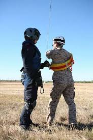 Joel Nas, a search-and-rescue crewman, helps Petty