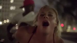 Sexy blonde gives Rome Major a blowjob out in the open