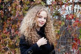 20,635 green eyes premium high res photos. Beautiful Young Woman With Curly Hair Green Eyes Girl In Casual Clothes Relaxing In Park In Good Autumn Weather Covered With Fallen Leaves Stock Photo Picture And Royalty Free Image Image 107066443