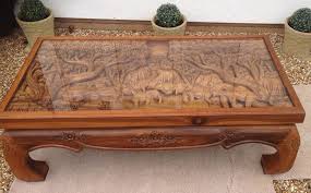 The best way to tie your room together is with a stylish coffee table. Solid Wood Hand Carved Elephant Scene Coffee Table With Glass Top