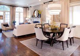 The kitchen, dining room and living room are beautifully distinguished by placing large jute chenille rugs in the center of each area while wood is used as a common material in the three spaces to merge them cohesively. Pin By Patrick And Melody Treadway On Furniture I Like Living Room Dining Room Combo Small Living Dining Living Room Dining Room Combo Layout