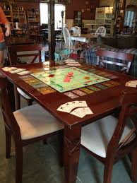 I Took A Monopoly Board And Some Game Pieces Glued Them To A Table Covered With Epoxy For Durability Then Recove Board Game Table Puzzle Table Table Games