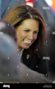 Republican presidential candidate, Rep. Michele Bachmann, R-Minn., arrives  at Idlewild Baptist Church with the church's Executive Pastor Brian  McDougall, left, and her husband Marcus Bachmann, second from right,  Sunday, Aug. 28, 2011,