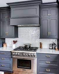 Though this designer opted for white cabinets on most of the kitchen, adding a deep gray pantry is a great way to add dimension to the space. 25 Ways To Style Grey Kitchen Cabinets