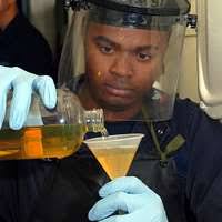 Engineman 3rd Class Joseph Casao stores an oil purifier