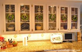 Metal clip hardware at the top and bottom of the rectangular looking glass secure the mirror in place, adding architectural appeal as it hangs vertically on bedroom and bathroom walls. Decorating With Preserved Boxwood Wreaths Between Naps On The Porch